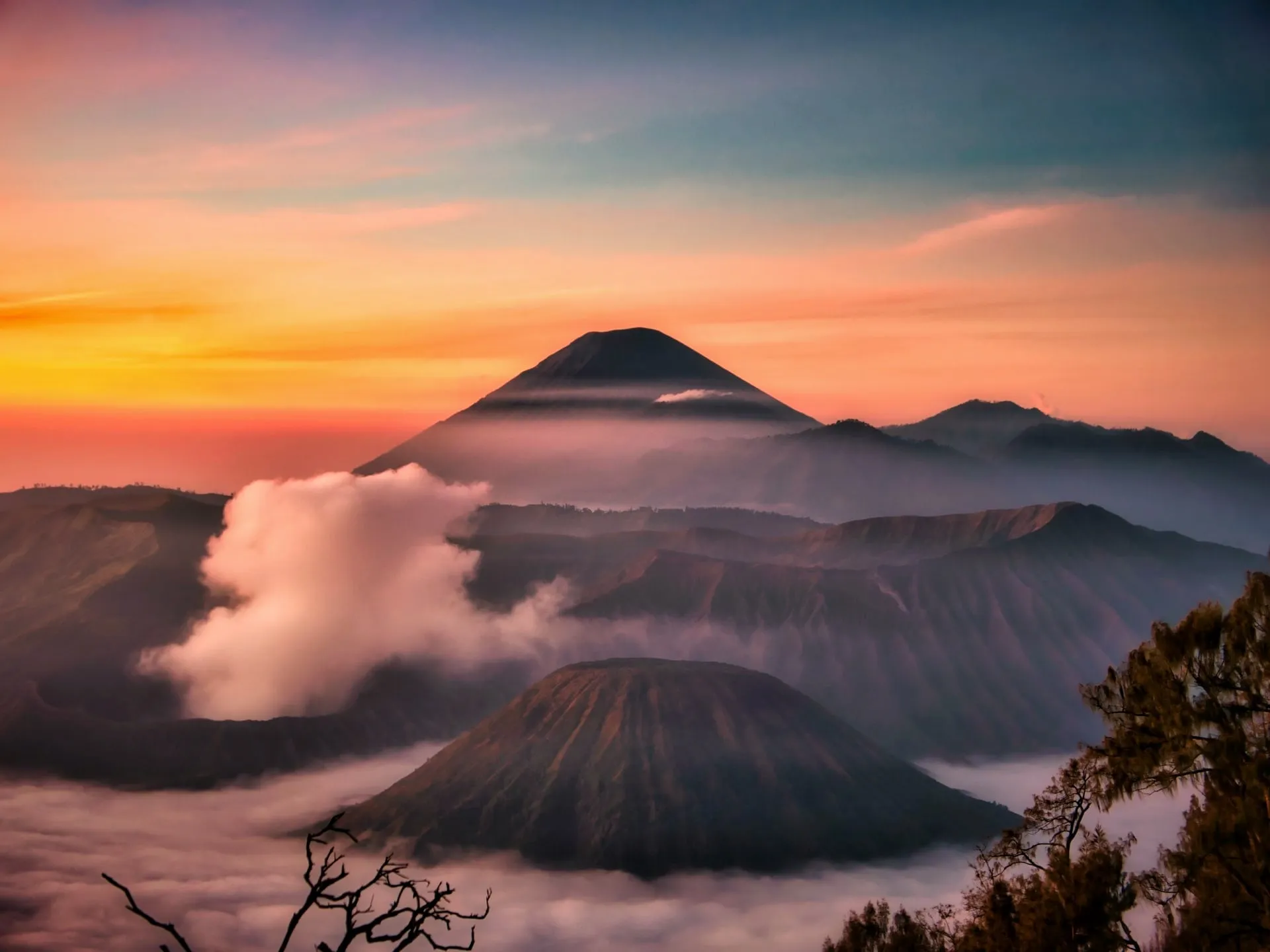 Sunrise over Mount Bromo with cloud filling the caldera.