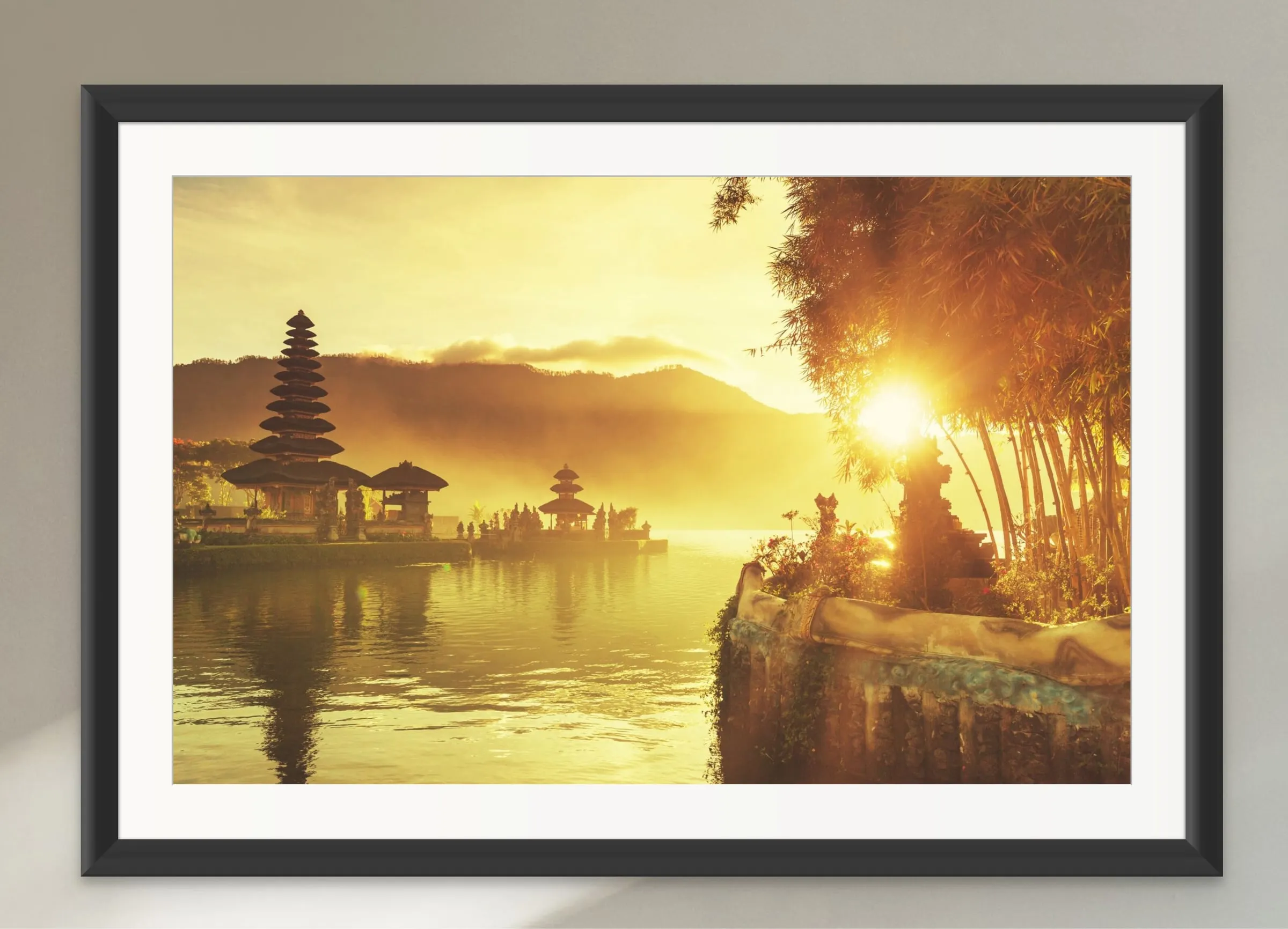 Framed print of a Balinese lake temple in golden sunrise light.